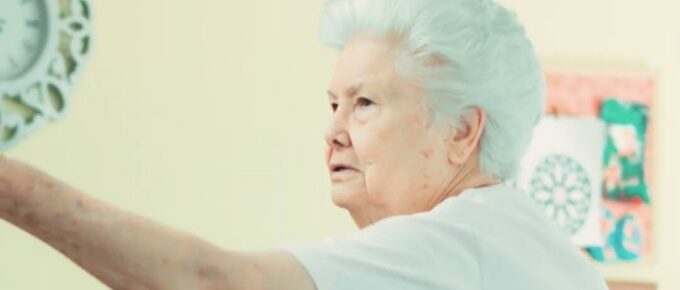 Resident taking aim at a Velcro dart board at Brookstone Terrace of Thomasville