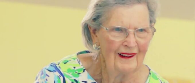 Smiling resident during air hockey and karaoke day at Brookstone Terrace of Thomasville