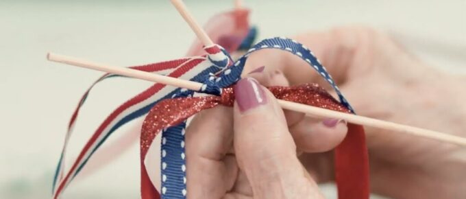 Resident crafting a patriotic flag at the Fourth of July art party in Thomasville