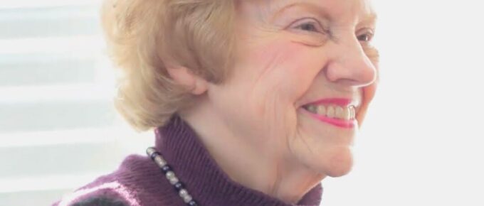 Smiling resident enjoying live piano music at Brookstone Terrace of Thomasville