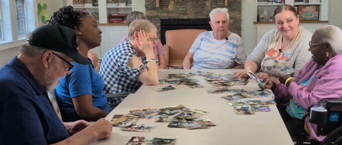 Residents and staff sharing photos and memories at Brookstone Terrace of Greensboro