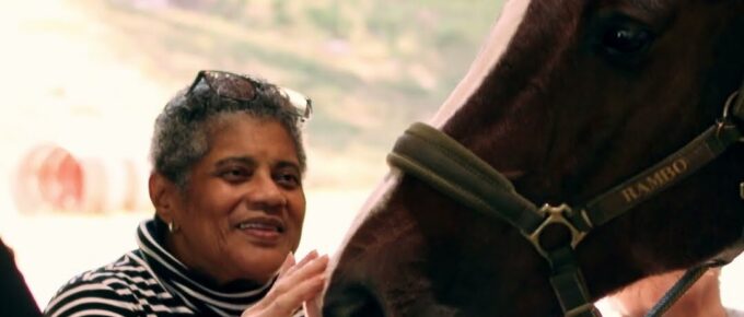 Resident meeting a horse during the HORSEPOWER outing with Brookstone Terrace of Greensboro