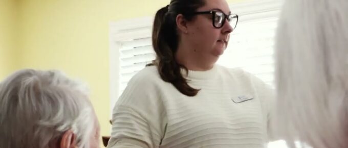 Bailey from Broad River Rehab leading Human Bingo with residents at Brookstone Terrace of Thomasville